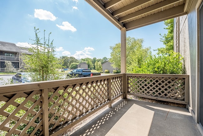 Enjoy serene moments on this cozy patio, surrounded by nature's beauty. - Corder Crossing