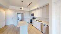 This contemporary apartment in Boca Raton, FL offers 880 square feet of efficiently designed living space. The single-story layout comprises three bedrooms, including a spacious 160 square foot primary bedroom, and two full bathrooms. The heart of the home is a modern, open-concept kitchen featuring sleek white cabinetry, stainless steel appliances, and a practical island. Light wood-look flooring runs throughout, complementing the crisp white walls and creating a bright, airy atmosphere. The bathrooms showcase large-format tile and glass-enclosed showers, with one including a bathtub option. Large windows in the bedrooms provide ample natural light and scenic views. The apartment's clean lines, neutral color palette, and minimalist design create a fresh and inviting living space. With its thoughtful layout and contemporary finishes, this apartment offers a stylish and comfortable urban living experience in a desirable Boca Raton location.
