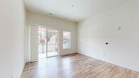 Located at 4733 S Packard Ave in Cudahy, Wisconsin, this thoughtfully designed 3-bedroom, 2-bathroom unit offers a clean, modern aesthetic throughout its well-utilized single-floor layout. The open-concept kitchen and living area serves as the heart of the home, showcasing soaring ceilings, warm hardwood-style flooring, and a sliding glass door that opens to a private balcony with outdoor views. The kitchen is outfitted with natural wood-toned cabinetry, a white quartz island and countertops, a classic subway tile backsplash, and a full suite of stainless steel appliances, including a French door refrigerator, electric range, microwave, and dishwasher. Pendant lighting adds a refined touch above the island. The three bedrooms are carpeted and bathed in natural light through large windows. The spacious primary bedroom provides a comfortable private retreat. Two full bathrooms serve the unit — one featuring a tub/shower combo and hardwood-style flooring, and the other offering a walk-in shower, wide vanity with ample storage, and a large mirror. A dedicated utility room and closet provide additional storage and functionality, completing this well-appointed Cudahy residence.