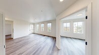 Located on the third floor at 425 Garden St in the heart of Santa Barbara, CA, this thoughtfully designed two-bedroom, one-bathroom residence offers a clean, modern aesthetic throughout. Wood-look flooring runs continuously across the entire unit, lending warmth and visual cohesion to each room. The open-concept kitchen and living area serves as the central hub of the home, featuring sleek white cabinetry, stainless steel appliances including a refrigerator, electric range, built-in microwave, and dishwasher, as well as recessed lighting and a convenient in-unit stacked washer and dryer. A private balcony extends the living space outdoors, accessible via a glass-paned door that invites natural light into the adjoining room. Both bedrooms are bright and airy, with large windows framing leafy treetop views of the surrounding Santa Barbara landscape. The primary bedroom offers a comfortable footprint with ample wall space, while the second bedroom mirrors the same clean, neutral palette. The bathroom is finished with a walk-in shower, wood-look flooring, and recessed lighting, maintaining the unit's modern sensibility. The overall ambiance is light, minimal, and move-in ready.