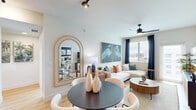 Located at 805 N Olive Ave in the heart of West Palm Beach, FL, this thoughtfully designed 2-bedroom, 3-bathroom residence offers a seamless single-floor layout with contemporary finishes throughout. The open-concept kitchen and living area serves as the centerpiece of the home, featuring a large quartz-topped island, two-tone cabinetry in white and deep navy, stainless steel appliances, and pendant lighting complemented by track lighting overhead. Light wood-look flooring flows throughout, enhancing the bright and airy ambiance.

The living area is bathed in natural light from large windows dressed in rich navy curtains, creating an inviting coastal atmosphere. A ceiling fan adds comfort, while the open dining area connects effortlessly to the kitchen and lounge space.

The primary bedroom is a serene retreat highlighted by a bold navy accent wall, generous walk-in closet with built-in wood shelving, and an en-suite bathroom featuring a sleek, glass-enclosed walk-in shower with crisp white tile and matte black fixtures. The second bedroom benefits from floor-to-ceiling windows offering sweeping city views, filling the room with abundant natural light. Two additional bathrooms and a convenient hallway complete this well-appointed residence.