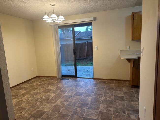 dining area off kitchen with sliding patio doors to private fenced in back yard - 6439 Armar Rd