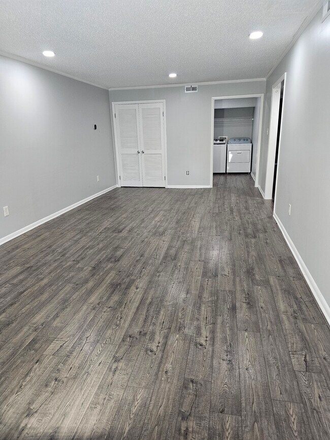 An exceptionally deep living room. plenty of space to design your perfect setup. - 8582 Chesapeake Blvd