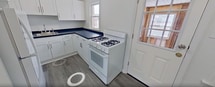 This well-designed 730 square foot apartment in Albany, NY offers a comfortable living space with two bedrooms and one bathroom. The interior showcases gleaming hardwood floors throughout most rooms, creating a warm and inviting atmosphere. The living area is spacious and bright, featuring large windows that allow natural light to flood the space.

The modern kitchen is equipped with a gas range, ample counter space with dark countertops, and white cabinetry for storage. The layout is functional, with a convenient L-shaped design. Adjacent to the kitchen, there's a small dining area perfect for casual meals.

Both bedrooms are generously sized, with the primary bedroom measuring 190 square feet. They feature the same polished hardwood floors and large windows, ensuring a light and airy feel. The bathroom is updated with a clean, classic look, featuring white tile work with black accents and a standard tub-shower combination.

Throughout the apartment, crisp white walls provide a neutral backdrop, allowing for personalization. The property benefits from radiator heating, ensuring comfort during colder months. Multiple hallways connect the rooms, enhancing the flow of the space. This apartment combines modern amenities with classic charm, offering a cozy home in a convenient Albany location.