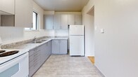 Located at 573 North Service Rd in Mississauga, ON, this well-appointed 2-bedroom, 1-bathroom unit offers a functional and comfortable layout across a single floor. Classic parquet hardwood flooring flows consistently throughout the main living areas and bedrooms, lending warmth and timeless character to the space.

The combined dining and living room is generously proportioned, filled with natural light from large windows and a sliding glass door that opens directly onto a private balcony. The balcony features a sleek glass-panel railing and offers open views of the surrounding neighbourhood and treetops. Baseboard heating runs along the exterior walls, ensuring comfort throughout the seasons.

The kitchen is neatly designed with grey cabinetry, granite-look countertops, a double stainless steel sink, and light tile flooring. A window above the sink brings in natural light, and a full-size refrigerator is included.

Both bedrooms are well-sized, with the primary bedroom offering a built-in sliding-door closet. Each room benefits from natural light and the same warm parquet flooring found throughout. Two closets provide ample storage across the unit.

The bathroom is clean and classic, featuring a full-size soaking tub with a tiled surround and chrome fixtures. The unit's bright, neutral palette and practical layout make it a versatile and inviting living space.