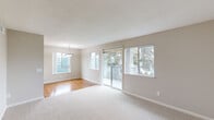 Located at 200 Greenbriar Cir in Petaluma, CA, this single-floor 2-bedroom, 1-bathroom home offers a practical and comfortable layout with clean, neutral finishes throughout. The combined living and dining area is bright and welcoming, featuring plush carpet, warm hardwood-style flooring in the dining section, and large windows alongside a sliding glass door that fills the space with natural light and provides direct access to an outdoor area. A pendant light fixture anchors the dining zone, adding a simple decorative touch. The galley-style kitchen is well-appointed with white cabinetry, granite-style countertops, stainless steel appliances including a gas range, microwave, refrigerator, and dishwasher, and hardwood-style flooring that extends underfoot. Both bedrooms are carpeted and offer a quiet, neutral atmosphere. The primary bedroom provides a comfortable footprint, while the second bedroom includes a mirrored sliding-door closet for added storage. The shared bathroom features a tub-shower combination, hardwood-style flooring, a granite-topped vanity, and clean white fixtures. Two hallways connect the rooms efficiently throughout the home's well-organized single-floor layout.