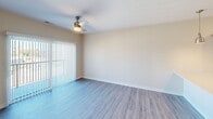 This contemporary 640 square foot apartment in Cedar Rapids, Iowa, offers a thoughtful blend of functionality and style. The space is efficiently designed with an open-concept layout that maximizes the living area. The kitchen is a standout feature, boasting ample cabinetry in a neutral tone, stainless steel appliances, and a convenient breakfast bar that seamlessly transitions into the living room.

The bedroom, measuring 130 square feet, is generously sized for the apartment's overall footprint. It features plush carpeting, a modern ceiling fan, and a large window that floods the room with natural light. The bathroom is well-appointed with a vanity, toilet, and bathtub/shower combination, finished with wood-look flooring for easy maintenance.

A key highlight is the dedicated laundry area, complete with full-sized, stacked washer and dryer units, and additional storage space. Throughout the apartment, wood-look flooring adds warmth and durability, while the neutral color palette creates a sense of spaciousness and allows for personal decorating preferences.

Large windows in the living area and bedroom provide ample natural light and views of the surrounding area. The overall ambiance is one of modern comfort, with clean lines and a practical layout that makes the most of every square foot.