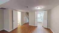 This two-story home offers a practical and well-organized layout across two levels. The main floor features wood-style flooring that extends through the open living areas, which are defined by a textured ceiling, ceiling fan, and neutral warm-toned walls. A staircase with white balusters connects the levels, while a half bath on the main floor adds everyday convenience. The kitchen is equipped with white cabinetry, light countertops, a double stainless steel sink beneath a window, and a dishwasher, providing a clean and functional cooking space.

Upstairs, two carpeted bedrooms offer a comfortable retreat, each featuring ceiling fans with light fixtures and windows with blinds that allow natural light. One bedroom includes a walk-in closet with built-in shelving, while access to a vanity area adds further utility. The full bathroom features a tiled tub and shower surround in classic white, complemented by light countertops and a chrome towel bar. Throughout the home, neutral tones, consistent finishes, and thoughtful details create a cohesive and move-in ready environment.