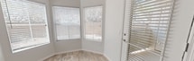 Located at 7990 E Snyder Rd in Tucson, AZ, this single-story 2-bedroom, 3-bathroom residence offers a clean, modern aesthetic throughout. The open living room is bright and airy, featuring wood-look flooring, a ceiling fan, and large windows that invite natural light and outdoor views. An arched doorway adds an architectural touch, connecting the living area to the rest of the home. The kitchen is a standout feature, offering dark espresso cabinetry, a herringbone-patterned tile backsplash, white quartz countertops, stainless steel appliances, and a convenient layout that flows into the dining and living spaces. The primary bedroom includes a ceiling fan, sliding glass doors that open to a private balcony, and ample natural light. The second bedroom also features a ceiling fan, wood-look flooring, and garden-facing windows. All three bathrooms are finished with wood-look tile flooring and white fixtures; one includes a tiled shower-tub combination with a dark vanity. A dedicated closet and hallway provide additional storage and easy navigation throughout the home. The balcony offers a serene outdoor retreat. Overall, the space presents a cohesive, contemporary design with neutral tones and quality finishes throughout.