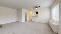 Located at 2040 Columbia Pike in Arlington, VA, this one-bedroom, one-bathroom residence offers a thoughtfully laid-out single-floor plan. The combined living and dining area is bright and open, featuring neutral carpet flooring, a ceiling fan with light fixture, and two large windows that flood the space with natural light and offer views of surrounding trees. A pass-through counter connects the living area to the kitchen, creating an open, connected feel.

The kitchen is well-appointed with rich dark espresso cabinetry, granite countertops, a double-basin sink, and wood-look flooring. A gas range and a window above the counter provide both functionality and natural light.

The generously sized bedroom includes a ceiling fan, plush carpet, a large window, and an impressive three closets—two double-door closets and an additional single closet—offering abundant storage. The bathroom features a full soaking tub with marble-style tile surround and a clean white vanity.

Additional features include a hallway with built-in shelving, a dedicated entry area with wood-look flooring, and multiple storage closets throughout. The residence presents a clean, neutral palette throughout, making it a versatile and comfortable living space in the heart of Arlington.