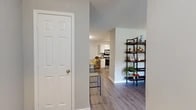 Located at 107 Ashford Dr in West Monroe, Louisiana, this single-story 2-bedroom, 2-bathroom home offers a thoughtfully designed layout across a comfortable footprint. The entryway opens through a hallway into an open-concept living and dining area, finished with light wood-look flooring and neutral gray walls that carry throughout the main living spaces. The living room is bright and inviting, featuring a ceiling fan, natural light from multiple windows, and views to the outdoors.

The kitchen is well-equipped with white shaker-style cabinetry, dark countertops, stainless steel appliances including a range with microwave and refrigerator, a dishwasher, a deep sink, and track lighting overhead — offering both functionality and style.

Both bedrooms are carpeted and feature ceiling fans, natural light from exterior windows, and closet storage. The generously sized primary bedroom includes a dedicated closet and a calm, restful ambiance. The two bathrooms are clean and functional, with one featuring a soaking tub and tiled surround with built-in shelving.

A dedicated laundry room houses a full-size washer and dryer, adding everyday convenience. Additional closet space and a hallway complete the interior. The home's cohesive design and practical layout make it an appealing and move-in-ready residence.