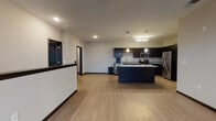 Located in Madison, WI (53719), this single-floor unit offers a thoughtfully designed open-concept layout that seamlessly connects the living and kitchen areas. The kitchen is a standout feature, showcasing dark espresso cabinetry, granite countertops, a central island with additional counter space, and a full suite of stainless steel appliances including a refrigerator, range, microwave, and dishwasher. Pendant lighting above the island and a multi-bulb chandelier add a modern, polished aesthetic. Light-toned hardwood-style flooring runs throughout the main living areas, complementing the neutral wall palette and creating a clean, contemporary feel.

The living area is generously proportioned, bathed in natural light from large windows, and features a ceiling fan for added comfort. A dedicated in-unit laundry area houses a full-size washer and dryer, offering everyday convenience. The bathroom is well-appointed with a dual-sink vanity topped with granite countertops, dark cabinetry, and a large mirror. The 3D floorplan reveals a well-organized layout with clearly defined bedroom and living spaces. Dark-trimmed doors and accents provide sharp contrast throughout, lending the unit a cohesive, modern character.