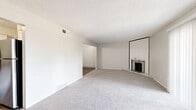 Located at 13050 W Cedar Dr in Lakewood, CO, this 2-bedroom, 2-bathroom single-floor home offers a well-planned layout with comfortable living spaces throughout. The living room is a standout area, featuring plush carpeting, a classic fireplace, and a large sliding glass door with vertical blinds that fills the room with natural light and provides access to the outdoors. The kitchen is thoughtfully updated with white shaker-style cabinetry, granite countertops, stainless steel appliances including a range and refrigerator, and light wood-look flooring that extends through the adjoining areas. A ceiling fan adds comfort to the kitchen space. Both bedrooms are carpeted and finished in neutral tones. The primary bedroom includes a walk-in closet with built-in shelving, while the second bedroom features a sliding door closet and a window with an outdoor view. The two bathrooms are cleanly finished with white cabinetry, granite-topped vanities, and wood-look vinyl flooring. One bathroom includes a full tub-shower combination, while the other features a single vanity with a towel bar. Textured ceilings are consistent throughout, contributing to the home's cohesive and practical design.