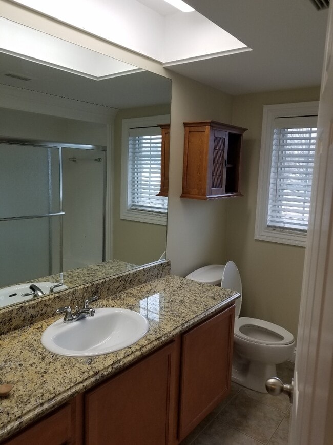 Freshly remodeled bath with granite counters and tiled shower - 2377 Walton Blvd