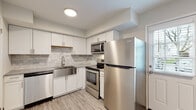 Located at 2637 Sawbury Blvd in Columbus, Ohio, this two-story residence offers a thoughtfully updated interior with a clean, modern aesthetic throughout. The entry level welcomes visitors with durable wood-look plank flooring that extends through the main living areas, complemented by neutral-toned walls and abundant natural light from multiple windows fitted with blinds.

The kitchen stands out as a highlight of the home, featuring crisp white shaker cabinetry, a marble-style tile backsplash, granite-look countertops, and a stainless steel farmhouse sink. A full suite of stainless steel appliances — including a refrigerator, electric range, over-the-range microwave, and dishwasher — completes the space, offering both style and functionality.

The living area on the main floor benefits from a front entry door flanked by windows that bring in natural light and views of the surrounding neighborhood. A staircase connects to the upper level, where the bedrooms are located. Each bedroom is carpeted for comfort and features generous closet space, including walk-in closets in select rooms. Windows in each bedroom provide natural light and outdoor views.

The bathroom is cleanly finished with wood-look flooring, a full tub-shower combination, and bright white fixtures. Utility access panels and HVAC vents are conveniently integrated throughout the home, reflecting well-considered infrastructure.