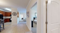 This thoughtfully designed single-floor residence offers a comfortable and functional layout across two bedrooms, two bathrooms, a combined living, dining, and kitchen area, plus a dedicated laundry room and two closets. Crown molding detail is carried consistently throughout, lending a polished, cohesive feel to the interior.

The kitchen is well-equipped with rich warm-toned cabinetry, granite countertops, black appliances including a refrigerator, range, and built-in microwave, and light tile flooring that extends into the dining area. A chandelier anchors the dining space, which flows naturally into the carpeted living room — a bright, welcoming area with access to natural light.

Both bedrooms feature soft carpet, neutral walls, and windows that let in ample natural light with views to the outdoors. The primary bedroom offers a comfortable, generously sized footprint with closet access. The bathrooms are finished with granite-topped vanities, warm wood cabinetry, tile flooring, and a tub-shower combination. The dedicated laundry room includes overhead wire shelving and hookups for a full-size washer and dryer. The overall ambiance is clean, neutral, and move-in ready.
