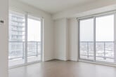 Located at 195 Deerfield Rd in Newmarket, Ontario, this modern 3-bedroom, 2-bathroom unit offers a clean, contemporary design throughout. Light wide-plank flooring flows seamlessly across the entire space, complementing the bright white walls and creating a cohesive, airy aesthetic.

The kitchen is efficiently designed with light grey cabinetry, a white subway tile backsplash, stainless steel appliances including a refrigerator, dishwasher, and range, and a sliding glass door that opens to a balcony with expansive views of the Newmarket skyline.

Each of the three bedrooms features floor-to-ceiling sliding glass doors that flood the rooms with natural light and provide direct access to outdoor balconies. The primary bedroom includes a sliding-door closet for organized storage. The elevated position of the unit affords broad views of the surrounding neighbourhood and beyond.

The two bathrooms are finished in crisp white tile. One features a soaking tub with a full tiled surround and chrome fixtures, while the other includes a glass-panel walk-in shower with mosaic tile flooring and a wall-mounted chrome fixture.

Connecting the rooms are two hallways, one of which features a large built-in storage unit with louvred ventilation panels, maximizing the utility of every square foot in this thoughtfully laid-out home.