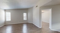 Located at 675 Jamestown Blvd in Altamonte Springs, FL, this single-story, 2-bedroom, 1-bathroom home offers a well-organized layout across its efficiently designed floor plan. Wood-look flooring runs throughout, complementing the neutral gray and beige tones found in every room.

The living room is bright and open, featuring natural light from slatted-blind windows, a ceiling fan with light fixture, and a textured ceiling. It connects seamlessly to the kitchen, which is outfitted with gray shaker-style cabinetry, granite countertops, a white subway tile backsplash, a peninsula breakfast bar, and stainless steel appliances including a range and refrigerator.

The spacious primary bedroom features tall ceilings and a large window that allows ample natural light. The secondary bedroom is similarly bright, with a window and light-toned wood-look flooring. Both rooms carry a clean, neutral aesthetic.

The bathroom includes a granite-topped vanity with gray cabinetry, a tub-shower combo with white tile surround, and direct access to a walk-in closet equipped with built-in wire shelving on multiple walls. Additional conveniences include a dedicated laundry area and a hallway connecting the main living spaces. The home presents a clean, move-in ready interior throughout.