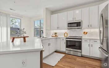 Spacious Kitchen with White Cabinets and Premium Fixtures - The Maggie