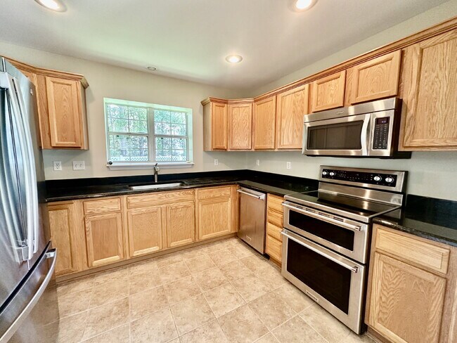 Building Photo - Four Bedroom Home with Private Fenced Back Yard in the Farm!