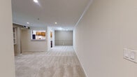 Located at 100 Calibre Lake Pkwy SE in Smyrna, Georgia, this one-bedroom, one-bathroom unit offers a well-organized single-floor layout with a comfortable and functional design. The spacious living room serves as the heart of the home, highlighted by a classic tile-surround fireplace with a white mantle and flanked by built-in shelving units — ideal for display or storage. Crown molding, recessed lighting, and neutral-toned walls lend the space a clean, polished ambiance. French doors connect the living area to an adjoining space, filling the room with natural light.

The galley-style kitchen features warm wood cabinetry, white countertops, hardwood-style flooring, and stainless steel appliances including a gas range, dishwasher, and refrigerator. Recessed lighting keeps the kitchen bright and practical.

The bedroom is generously sized with plush carpeting, a window overlooking lush greenery, and a dedicated closet. A sliding glass door — topped with a ceiling fan — opens to an outdoor patio, bringing in natural light and outdoor views.

The bathroom includes a full soaking tub with a white tile surround and chrome fixtures. A utility room and hallway complete this efficiently designed layout, offering practical everyday living in a well-appointed Smyrna community.