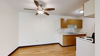 Located at 1776 Saint Clair Ave in Saint Paul, Minnesota, this single-floor, three-bedroom, one-bathroom home offers a practical and comfortable layout. The living area features neutral carpet flooring, clean white walls, and large windows that allow generous natural light to fill the space. Baseboard heating and a wall-mounted air conditioning unit provide year-round climate control, while ceiling fans in multiple rooms add to the overall comfort.

The kitchen is equipped with warm wood cabinetry, a countertop sink, and light hardwood flooring that transitions smoothly into the adjacent living areas. The spacious primary bedroom stands out for its generous proportions, with multiple windows offering views of the surrounding neighborhood, plush carpet underfoot, and a ceiling fan overhead. The additional two bedrooms are similarly carpeted and naturally lit, each featuring ceiling fans and sliding or hinged wood closet doors.

The full bathroom is appointed with a wood-toned vanity, mosaic tile flooring, a tub-shower combination with tile surround, and a small window for ventilation. A connecting hallway ties the rooms together in a straightforward, functional flow. This home provides a solid and well-maintained living environment in a established Saint Paul neighborhood.