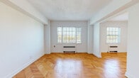 Located at 2685 E 130th St in Cleveland, Ohio, this single-floor unit offers a well-organized layout with a clean, neutral aesthetic throughout. The living areas are a standout feature, showcasing beautiful herringbone parquet wood flooring that adds warmth and character to the space. Large windows allow generous natural light to fill the rooms, complementing the bright white walls and creating an open, airy atmosphere. A ceiling fan in one of the rooms adds both function and style.

The galley-style kitchen is thoughtfully appointed with gray cabinetry, granite-look countertops, a subway tile backsplash, stainless steel appliances including a dishwasher and electric range, and light ceramic tile flooring. Ample cabinet storage lines both sides of the kitchen, maximizing utility in the space.

The bathroom is finished in crisp white tile wainscoting, with classic fixtures including a chrome faucet and a pedestal-style sink, maintaining a timeless and clean look. Interior doors throughout feature classic four-panel detailing with vintage-style crystal and black hardware, adding a charming architectural touch. The overall design of the unit balances classic details with modern updates, offering a functional and inviting living environment.