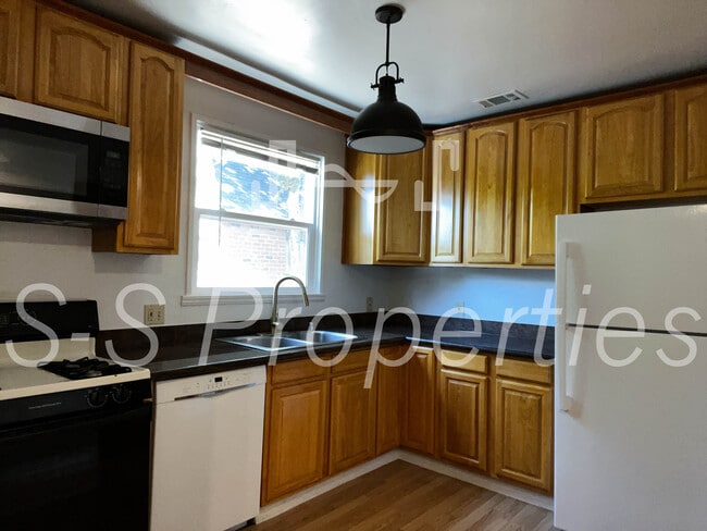 Kitchen with solid wood cabinets & GE refrigerator - 2614 San Jose Way