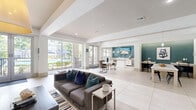 Located at 2350 Bagby St in Houston's vibrant Midtown neighborhood, this expansive single-floor amenity facility spans an impressive footprint designed to serve as a premier community hub. The space is organized into several distinct yet interconnected zones, each thoughtfully designed with modern finishes and a cohesive color palette of crisp whites, teal accent walls, and contemporary furnishings.

The open-concept clubroom greets visitors with large-format light tile flooring, recessed lighting, and an abundance of natural light from full-height glass doors. Multiple seating and dining arrangements, a wet bar with teal tile backsplash, and pendant lighting create a welcoming social environment.

The fitness center is comprehensively outfitted with a wide array of cardio machines, including treadmills, ellipticals, and cable machines, all set atop a herringbone-patterned carpet floor. Ceiling fans and large windows ensure a comfortable workout environment. An adjoining dedicated cycling studio features rows of spin bikes, full-length mirrors, a projection screen, and light wood-look flooring, providing an immersive group fitness experience. A free-weights area with dumbbells, stability balls, and cycling bikes rounds out the exercise offerings.

The game room provides a lively social outlet, anchored by a billiards table beneath a statement pendant light, high-top bar seating, flat-screen TVs, and bold teal walls adorned with curated artwork.
