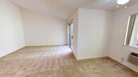 Located at 3340 Cortese Cir in San Jose, California, this single-story residence offers a practical and well-organized layout with a clean, neutral aesthetic throughout. The living area is generously proportioned, featuring wall-to-wall beige carpeting, crisp white walls, and a textured ceiling that adds subtle dimension. Sliding glass doors open directly to an outdoor space, allowing natural light to fill the room and providing convenient exterior access.

The kitchen is efficiently designed in a galley-style configuration, featuring warm wood-toned cabinetry on both sides, light composite countertops, and tile flooring. White appliances, including a refrigerator and an electric range, are included. An adjacent hallway connects to built-in shelving storage, offering practical organizational space.

The bedrooms are carpeted and bright, each featuring windows that bring in natural light and views of surrounding greenery. Vaulted or angled ceilings in certain areas add visual interest and a sense of openness. Baseboard heating units are present beneath the windows, ensuring comfort throughout the seasons.

The bathroom is finished with tile flooring in a warm earth tone and includes a full tub-and-shower combination with white tile surround, built-in shelving, a wood-toned vanity, and stone-look countertops, presenting a tidy and functional space overall.