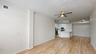 Located at 2760 SW 115th Ave in Miramar, Florida, this single-floor 2-bedroom, 2-bathroom home offers a clean, modern aesthetic throughout. Light wood-style flooring flows consistently across the entire residence, complemented by crisp white walls and abundant natural light.

The open-concept kitchen and living area serves as the heart of the home. The kitchen features white shaker cabinetry, a large peninsula with a white quartz countertop and undermount sink, stainless steel appliances including a range, microwave, and refrigerator, and a tile backsplash. A skylight overhead fills the kitchen with natural light. The adjoining living room is spacious and bright, with multiple windows framing outdoor views and a ceiling fan overhead.

The primary bedroom is generously sized, offering a ceiling fan, natural light from a window, and access to a dedicated closet. The second bedroom is equally well-lit and comfortable, also featuring a ceiling fan. Both bathrooms are finished with white vanities, wood-look flooring, and tiled shower-tub combinations with classic diamond accent details. A dedicated laundry area accommodates a full-size washer and dryer. The home is completed by an entrance, hallway, and additional closet space, providing practical and functional living throughout.
