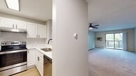 Located at 3200 Inglewood Ave S in St. Louis Park, MN, this two-bedroom, one-bathroom residence offers a well-designed single-floor layout with a thoughtful mix of updated finishes and functional living spaces.

The kitchen is a standout feature, outfitted with white shaker-style cabinetry, white countertops, and a full suite of stainless steel appliances including a refrigerator, electric range, and dishwasher. Light wood-look flooring adds a warm, clean aesthetic to the space, which opens via a pass-through to the adjoining living area.

The living room is generously sized, carpeted for comfort, and filled with natural light from a sliding glass door that leads to a private balcony with outdoor views of surrounding greenery. A ceiling fan with a light fixture completes the room.

The primary bedroom is a comfortable retreat with carpet flooring, a window overlooking lush exterior foliage, and access to a walk-in closet equipped with built-in shelving and hanging rods. The second bedroom also features carpet and mirrored sliding closet doors.

The bathroom is finished with white tile flooring, white tile wainscoting, a single vanity with white cabinetry, and black matte hardware and fixtures throughout, lending a modern contrast to the neutral palette.