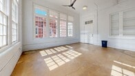 This 820 square foot apartment in Columbia, SC, showcases a harmonious blend of historic character and modern convenience. The space features three bedrooms, including a primary bedroom of 130 square feet, and two full bathrooms. High ceilings and expansive windows throughout create an airy, light-filled atmosphere.

The apartment's kitchen is a highlight, boasting sleek white cabinetry, stainless steel appliances, and a subway tile backsplash. The open layout seamlessly connects the kitchen to other living areas, enhancing the sense of space.

Hardwood floors in warm tones grace several rooms, while others feature durable concrete flooring, adding an industrial-chic touch. The bathrooms are tastefully appointed with modern fixtures, including a vanity with a granite countertop in one.

A standout feature is the abundance of natural light, streaming through large, multi-paned windows that offer views of the surrounding brick buildings, hinting at the property's urban setting. The apartment also includes a closet for additional storage.

The interior design embraces a clean, minimalist aesthetic with white-painted brick walls and neutral color palettes, providing a blank canvas for personal style. Modern amenities such as recessed lighting and a ceiling fan ensure comfort and functionality.

This apartment seamlessly combines the charm of a historic building with the conveniences of contemporary living, making it an ideal urban dwelling in the heart of Columbia.