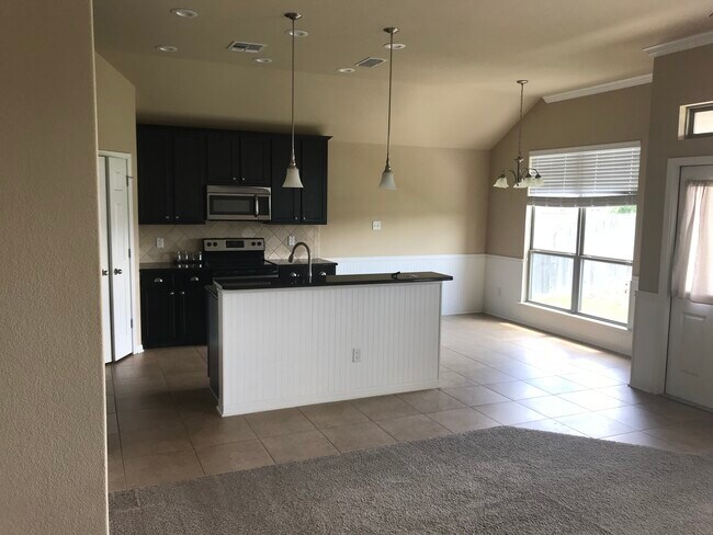 Open kitchen and dining nook into main living room. Kitchen includes spacious pantry. - 5825 Worthing