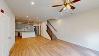 This well-appointed two-story home in Aberdeen, Maryland offers three bedrooms, four bathrooms, and a thoughtfully designed layout spread across two floors. The main level features an open-concept kitchen and living area with warm hardwood-style flooring and recessed lighting throughout. A ceiling fan anchors the living space, which flows seamlessly into a modern kitchen outfitted with gray shaker-style cabinetry, granite countertops, stainless steel appliances including a refrigerator, range, and built-in microwave, a large central island, and pendant lighting. A pantry provides additional storage. Upstairs, the generously sized primary bedroom features hardwood-style flooring, a ceiling fan, ample natural light from multiple windows, and an en suite bathroom with a walk-in shower, granite vanity, and access to a walk-in closet. Additional bedrooms are carpeted and include closet space. Bathrooms throughout are finished with granite countertops and gray cabinetry, with one bath offering a double-sink vanity and soaking tub. The home also includes a dedicated laundry room with full-size washer and dryer, a hallway, and an attached single-car garage with an automatic opener.