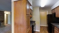 Located at 5014 Sedgewick Dr in Raleigh, North Carolina, this single-story home offers a functional and comfortable layout designed for everyday living. The kitchen is a standout feature, showcasing rich, warm-toned wood cabinetry that extends from floor to ceiling, providing generous storage space. Dark countertops offer a complementary contrast to the cabinetry, while an electric range sits neatly integrated into the kitchen setup. A textured ceiling adds a classic touch to the space, and flush-mounted lighting ensures the kitchen remains well-lit. The flooring throughout is hardwood-style, lending warmth and continuity as it flows from the kitchen into the adjoining areas. Neutral-toned walls create a clean, versatile backdrop that adapts well to a variety of interior styles. A glimpse into the connecting rooms reveals an open, airy layout with consistent flooring and ample natural wall space. The overall ambiance of the home is practical and inviting, with design choices that prioritize both utility and comfort — making it a solid, move-in-ready option in the Raleigh area.