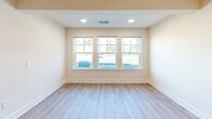 Located at 7006 Brookfield Rd in Columbia, SC, this single-story, 2-bedroom, 2-bathroom home offers a well-organized and functional layout throughout its comfortable footprint. The open-concept kitchen and living area serves as the heart of the home, featuring light luxury vinyl plank flooring that extends seamlessly through the common areas. The kitchen is equipped with rich dark wood cabinetry, stainless steel appliances including a refrigerator, electric range, and microwave, as well as a peninsula with a double sink — ideal for both everyday cooking and casual dining. The living room benefits from recessed lighting and a bank of large windows that invite abundant natural light. Both bedrooms are carpeted for comfort and include ceiling fans with lighting. The generously sized primary bedroom features a dedicated closet, while the second bedroom also offers a natural light-filled window. Both bathrooms are finished with wood-toned vanity cabinetry, light countertops, LVP flooring, and full tub-shower combinations with clean white surrounds. The home's neutral color palette and consistent finishes throughout create a bright, cohesive, and move-in ready atmosphere.