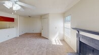 Located in Waco, TX, this single-story, one-bedroom, one-bathroom unit offers a well-organized layout designed for comfortable everyday living. The living room is bright and generously sized, featuring plush carpeting, a ceiling fan with light fixture, a cozy fireplace, and a sliding glass door that opens to a private balcony, filling the space with natural light. Adjacent to the living area is a functional kitchen equipped with warm wood cabinetry, a stone-look countertop, and a window that brings in additional natural light. The bedroom is a comfortable retreat with soft carpeting, a ceiling fan, a window with blinds, and direct access to a spacious walk-in closet outfitted with dual wire shelving systems for ample storage. A second closet provides additional storage flexibility. The bathroom features wood-look vinyl flooring, a wood vanity cabinet, a soaking tub, and clean, neutral finishes throughout. A dedicated hallway connects the main living areas, and a utility area with an electrical panel is also present. Textured ceilings are consistent throughout the unit, contributing to its classic residential character.
