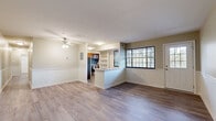 Located at 2404 Brightseat Rd in Hyattsville, MD, this well-appointed 4-bedroom, 2-bathroom single-story home offers a thoughtfully designed layout across a generous single floor. The open living and dining area is anchored by wood-style flooring, neutral warm-toned walls with classic wainscoting detail, and a ceiling fan overhead. Large grid-pane windows flood the space with natural light, offering pleasant outdoor views. A half-wall peninsula seamlessly connects the living area to the kitchen, which features warm wood cabinetry, stainless steel appliances including a gas range and refrigerator, a mosaic tile backsplash, and light stone countertops. An in-unit washer is also conveniently housed in the kitchen. The bathrooms are clean and modern, with one featuring marble-style tile surrounding a full soaking tub with glass enclosure and brushed nickel fixtures. Each bedroom is well-sized with hardwood-style flooring; the primary bedroom is notably spacious and includes a closet. Additional bedrooms are bright, with large windows bringing in natural light and outdoor views. A hallway, closet, and unclassified utility space round out the floor plan, providing practical storage and circulation throughout this comfortable Hyattsville home.