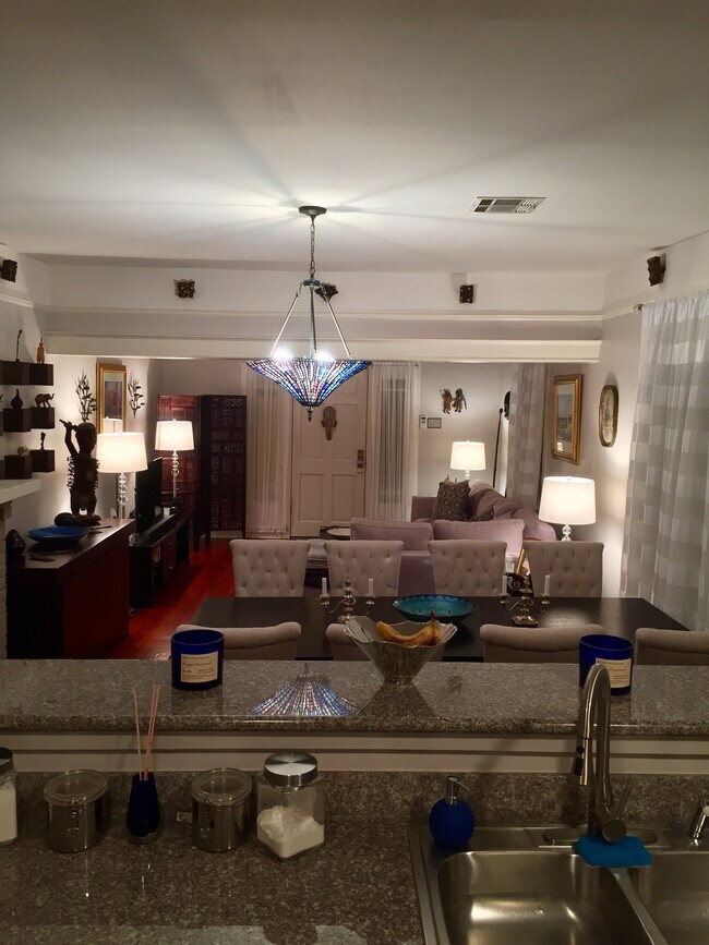 View from the kitchen into an open floorspace towards front door - 803 Voisin St