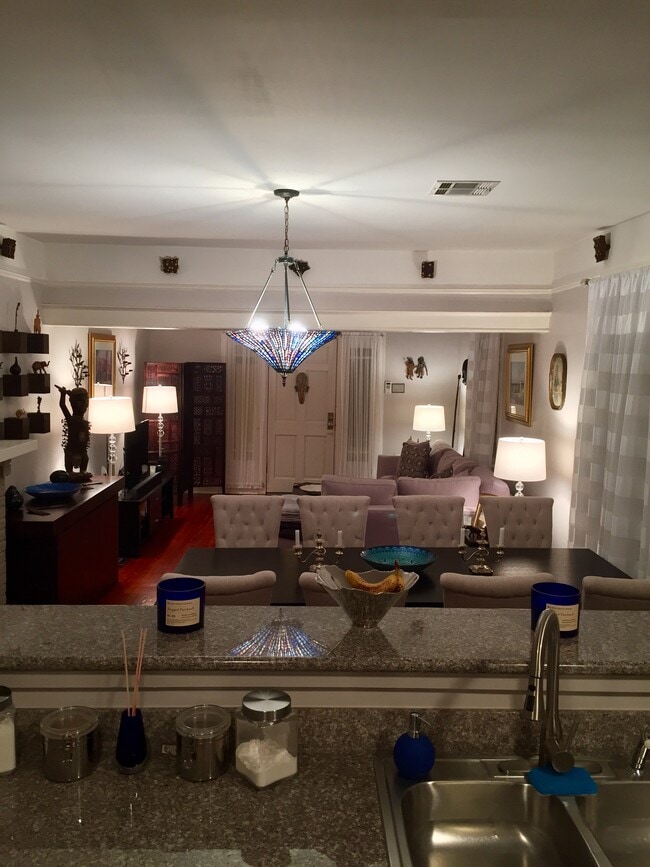 View from the kitchen into an open floorspace towards front door - 803 Voisin St