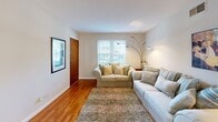 Located at 4811 Monroe Rd. in Charlotte, NC, this single-floor residence offers a well-organized layout with a cohesive, warm aesthetic throughout. Rich hardwood flooring runs through the main living areas, lending continuity and a classic character to the space.

The living room is bright and welcoming, featuring neutral walls, natural light from a double window, and ample room for comfortable seating arrangements. Framed artwork accents the walls, adding a personalized touch to the relaxed atmosphere.

Adjacent to the living area is a dedicated dining space, bathed in natural light through a large window. The room comfortably accommodates a round dining table and provides direct access to an exterior door, offering convenient entry and exit.

The kitchen is efficiently designed, featuring warm wood cabinetry, a double sink, electric range, and a full-size refrigerator. Light-toned flooring and a practical layout make this a functional space well-suited for everyday cooking.

The bedroom is a calm and restful retreat, highlighted by warm hardwood floors, neutral walls, and generous natural light from a large window. The room comfortably fits a queen-size bed with matching wood furniture, creating a cohesive and inviting space.

The bathroom includes a full tub-shower combination with white tile surround, a window for natural ventilation, and clean, simple finishes throughout.