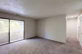 Located at 913 N Chelton Rd in Colorado Springs, Colorado, this single-floor, one-bedroom, one-bathroom residence offers a practical and comfortable layout across a well-utilized floor plan. The living room is carpeted and features a textured ceiling, neutral walls, and a sliding glass door that opens directly onto a private balcony, allowing natural light to fill the space and providing views of the surrounding tree canopy. An adjacent dining area complements the living space, creating a natural flow for daily living. The kitchen is equipped with wood cabinetry, light-toned countertops, a built-in electric range, a dishwasher, and tile flooring, along with convenient access to a utility area. The bedroom is carpeted, with a window overlooking the outdoors, offering a quiet and naturally lit retreat. Two closets provide ample storage throughout the unit. The bathroom includes a full tub-shower combination with clean white finishes and tile flooring. A hallway connects the key spaces efficiently. Throughout the residence, a consistent neutral color palette and textured ceilings contribute to a understated, functional aesthetic well-suited to Colorado Springs living.