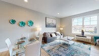 Located at 455 Livingston St in Norwood, NJ, this thoughtfully designed single-floor residence offers a cohesive, modern aesthetic throughout. The open-concept living and dining area is bright and welcoming, featuring light hardwood flooring, recessed lighting, and a large window that fills the space with natural light. A vibrant area rug anchors the living space, complemented by contemporary furnishings and curated wall décor in teal and gray tones that carry through the entire unit.

The kitchen is efficiently laid out with rich dark-stained cabinetry, sleek granite countertops, stainless steel appliances including a gas range and refrigerator, and a peninsula with bar seating — ideal for casual dining or entertaining. The bedroom is generously proportioned, offering ample closet storage and natural light from a large window, maintaining the same warm hardwood flooring and neutral palette found throughout the home.

The bathroom features tile flooring, a dark granite vanity, and clean, modern finishes. A hallway connects the rooms seamlessly, with crisp white panel doors and clean architectural trim adding a polished, finished feel. The overall ambiance is modern, warm, and move-in ready.