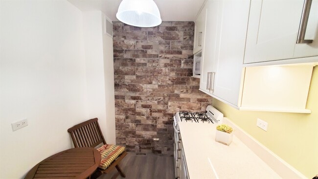 From the brick accent wall to the custom cabinets no detail has been overlooked. - 400 Central Park W