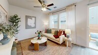 Located in Pflugerville, TX, this efficiently designed 2-bedroom, 1-bathroom single-story home offers a clean, modern aesthetic defined by crisp white walls, recessed lighting, and light-toned wood-look flooring that flows consistently throughout the space. A welcoming hallway connects the bedrooms, bathroom, and storage areas to the main living zone, lined with paneled white doors and a louvered closet for added organization. The combined kitchen and living area serves as the heart of the home, featuring a well-appointed kitchen with white shaker-style cabinetry, granite countertops, a classic tile backsplash, and a full suite of stainless steel appliances including a refrigerator, range, microwave, and dishwasher. A window above the sink brings in natural light, while the open layout accommodates a dining area alongside the living space. The primary bedroom includes a ceiling fan, a built-in closet with shelving, and direct sightlines to the kitchen. The second bedroom offers a ceiling fan, a large window with natural light, and a calm, neutral atmosphere. The bathroom is finished with granite countertops, a tiled walk-in shower with glass enclosure, and a high window for privacy with light. The overall ambiance is bright, clean, and functional.