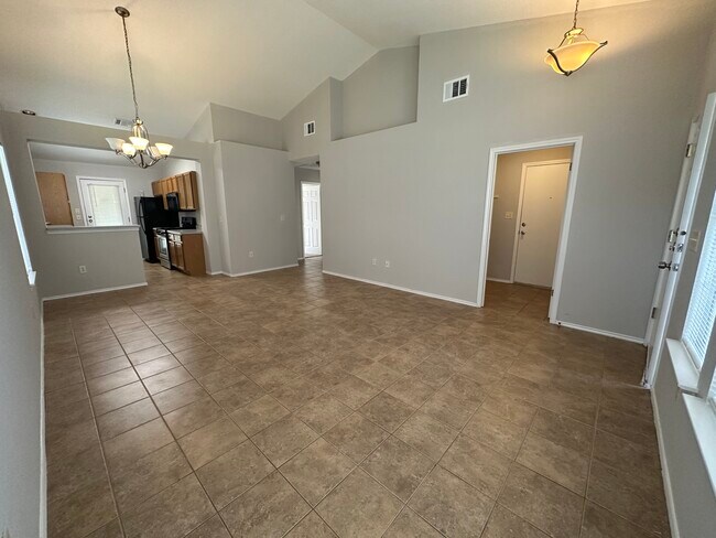 Spacious living room with natural light and vaulted ceiling - 2906 Whisper Oaks Ln