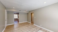 Located at 625 S 35th St in Omaha, Nebraska, this well-appointed 1-bedroom, 1-bathroom residence offers a thoughtfully organized single-floor layout. Throughout the unit, light-toned luxury vinyl plank flooring, neutral gray walls, and crisp white trim create a clean, modern aesthetic that maximizes the sense of space.

The open living and dining area flows naturally into the kitchen, which features white cabinetry, white quartz countertops, a white tile backsplash, stainless steel appliances, and a bright window overlooking the exterior. Recessed lighting and natural light from multiple windows keep the space feeling airy and welcoming.

The bedroom is a comfortable, well-proportioned room equipped with a ceiling fan, a large window for natural light, and access to multiple closets, providing ample storage. A hallway connects the main living areas to the bedroom and bathroom.

The bathroom is bright and updated, showcasing marble-style tiled tub surround, light flooring, a window, and in-unit laundry hookups — a practical and efficient use of space. A dedicated utility room and additional closets round out the storage options throughout the unit, while the textured ceilings add a subtle architectural detail consistent across all rooms.