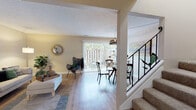 Located at 41158 Roberts Ave in Fremont, California, this two-story home offers a well-organized layout with thoughtfully designed living spaces across both levels. The main floor features warm luxury vinyl plank flooring throughout, creating a cohesive and easy-to-maintain foundation. The open living and dining area is bathed in natural light from large sliding glass doors that lead to an outdoor patio, offering pleasant views of the exterior. A staircase with a metal railing connects the two floors, adding a contemporary touch to the interior. The kitchen is outfitted with white cabinetry, granite countertops, stainless steel appliances including a dishwasher, and a window that brings in additional natural light. A cozy dining nook with a ceiling fan is conveniently adjacent to the kitchen. Upstairs, the bedrooms feature plush carpeting and textured ceilings, providing a comfortable and quiet retreat. The bathroom includes a dark granite vanity countertop, a glass-enclosed shower, and a frosted window for natural light and privacy. The attached garage offers generous storage space with wood-paneled walls and a concrete floor, providing direct interior access to the home. Overall, the space presents a functional and inviting layout suited for everyday living.