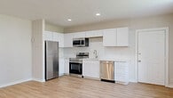 Located at 30 Black Creek Rd in Esopus, NY, this thoughtfully designed one-bedroom, one-bathroom unit offers a clean, modern aesthetic throughout its efficiently laid-out single floor. Light-toned hardwood flooring runs continuously through all living areas, creating a cohesive and airy feel.

The open-plan kitchen and living room serve as the heart of the unit. The kitchen is well-appointed with crisp white shaker-style cabinetry, a classic white subway tile backsplash, light stone countertops, and a full suite of stainless steel appliances including a refrigerator, electric range, over-the-range microwave, and dishwasher. Recessed lighting illuminates the space effectively.

The living area flows naturally from the kitchen, offering an open and flexible space with recessed lighting and neutral warm-toned walls. The bedroom is a comfortably sized private retreat featuring a window that brings in natural light, baseboard heating, and access to two closets, providing ample storage. The clean, neutral palette of soft gray and white tones throughout the unit lends itself to a calm and versatile living environment. A full bathroom completes the layout, rounding out this well-finished and move-in-ready unit.